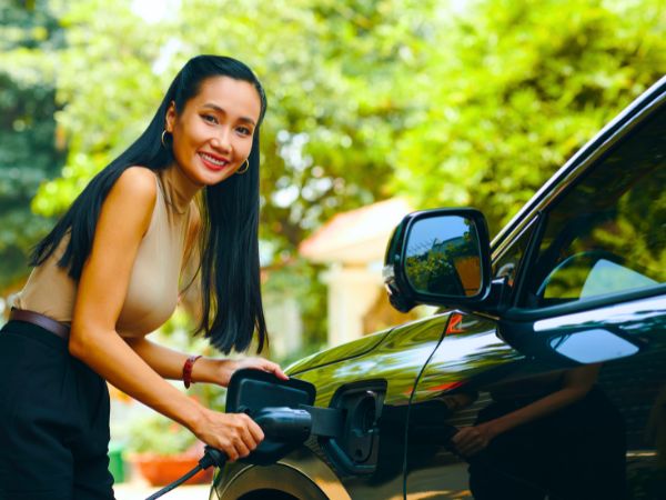 Woman Charging an Electric Car